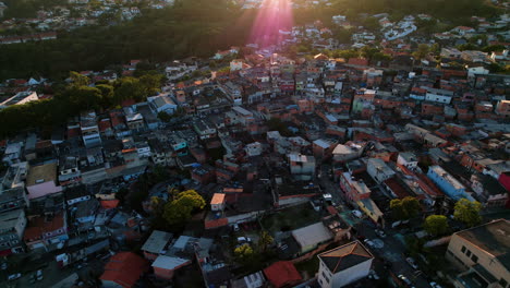 Aerial-view-over-a-shantytown,-sundown-in-South-America---reverse,-drone-shot
