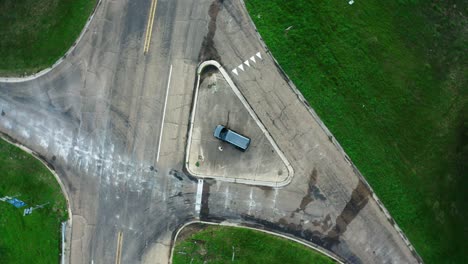 top-down spinning aerial view of car parked illegally on safety island