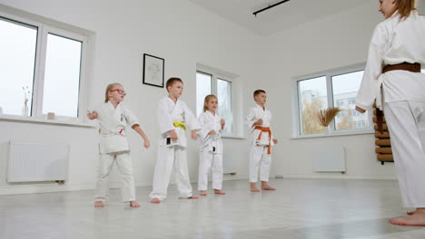 Caucasian-martial-arts-teacher-teaching-kids