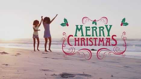 Animation-of-merry-christmas-over-happy-african-american-mother-and-daughter-on-beach