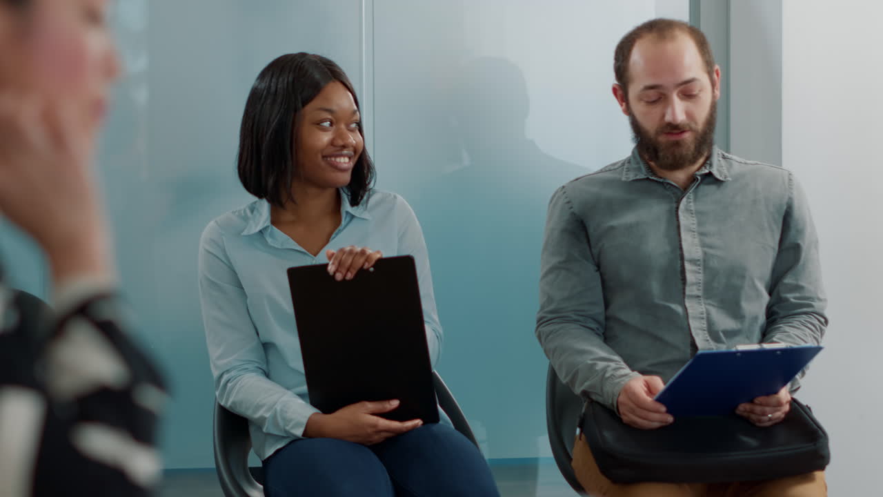 Man and woman discussing hiring application in queue