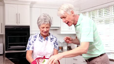 Senior-happy-couple-baking-cookies-