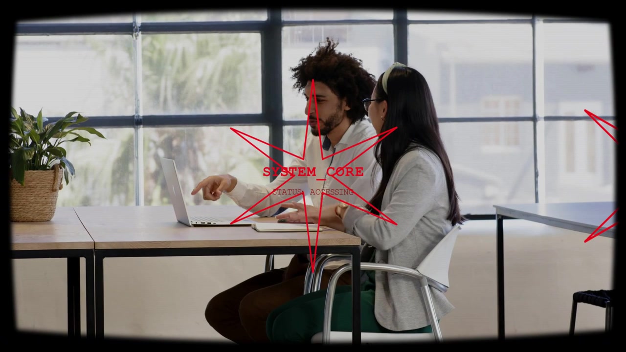 Man tapping phone pointing at laptop, woman typing, reviewing business data, red overlay appearing