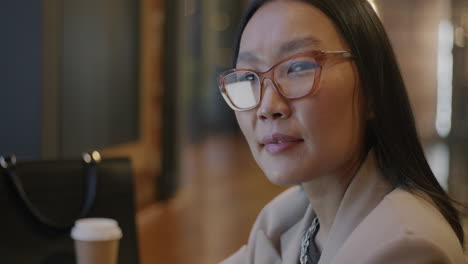 smiling asian businesswoman in a cafe