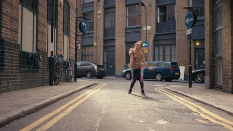 Contemporary-funky-mixed-race-woman-street-dancer-dancing-freestyle-in-the-city