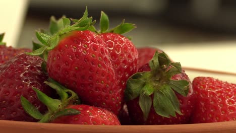 zooming out of a bowl of fresh strawberries
