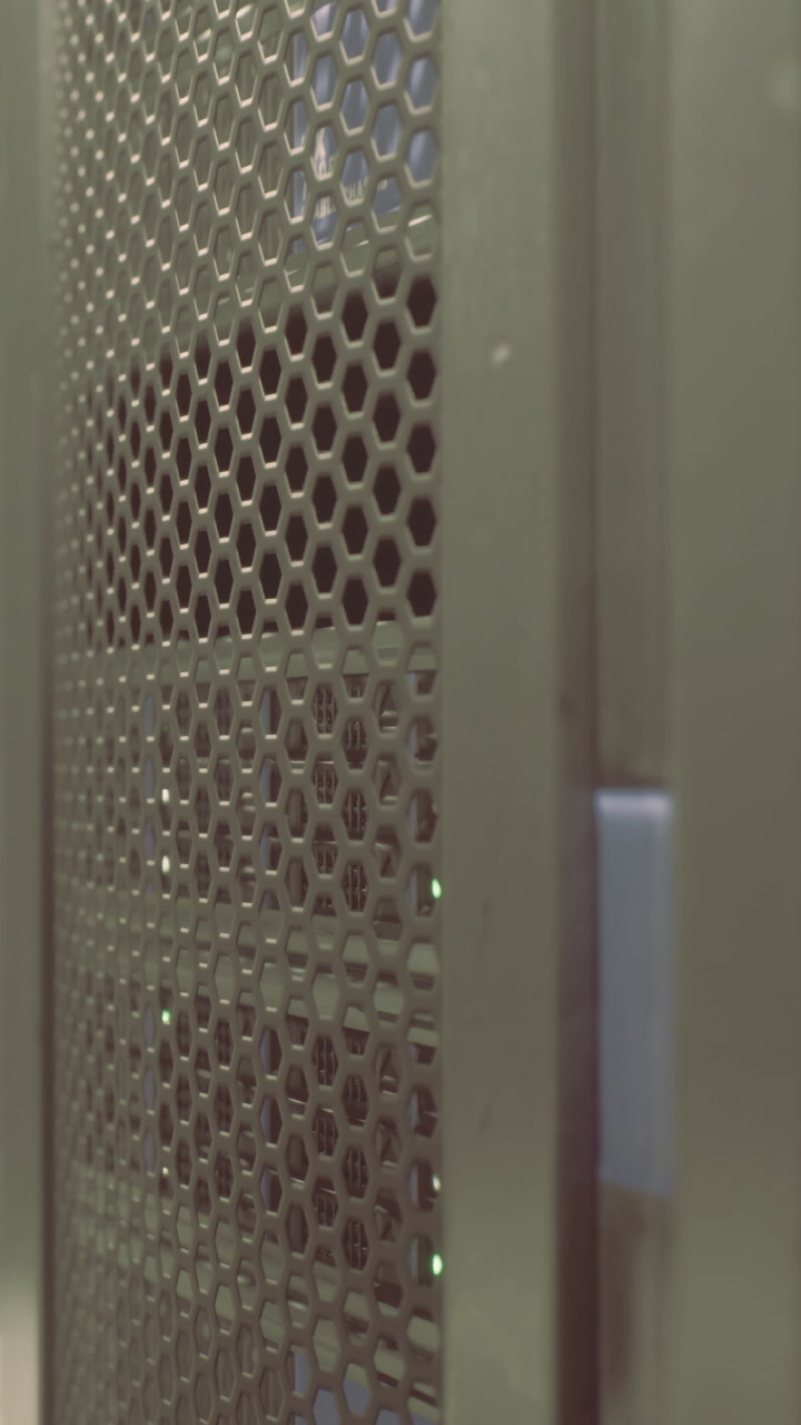 Server rack with green lights at a data center in the evening hours