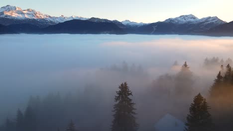 Dense-clouds-over-mountain-valley-at-sunset