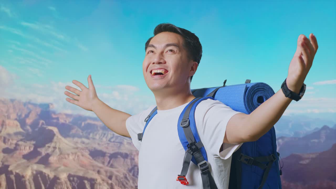 Close Up Side View Of Asian Male Hiker With Mountaineering Backpack Spreading Arms Enjoy Looking The View Around While Traveling At The Top Of Mountain