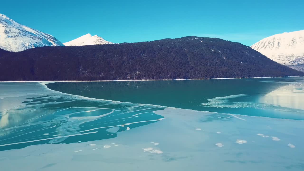 겨울철 알래스카의 눈 덮인 호숫가 산을 촬영한 4k 드론 영상