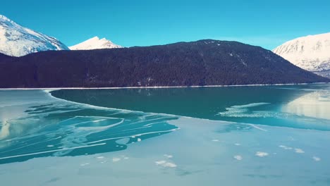 4K-Drone-Video-of-Snow-Covered-Lakeside-Mountains-in-Alaska-During-Winter