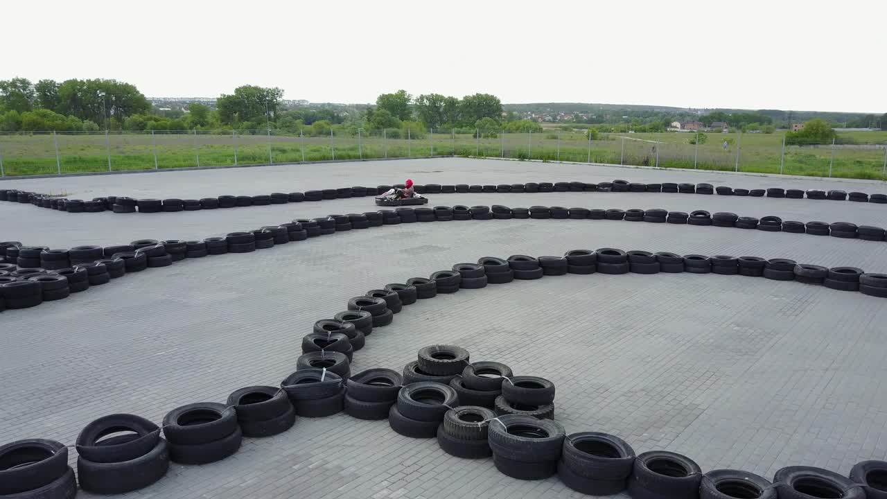 Driver In Helmet On Kart Circuit. VINNITSA, UKRAINE - MAY 2017: Europe Day, drivers in karts wearing helmet, racing suit participate in kart race