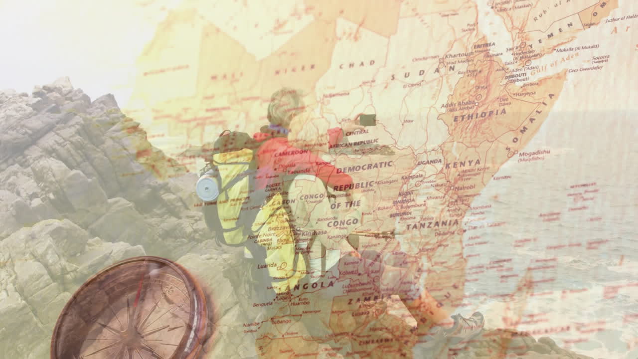 Couple hiking coast using phone taking selfie with Africa map overlay showing navigation technology