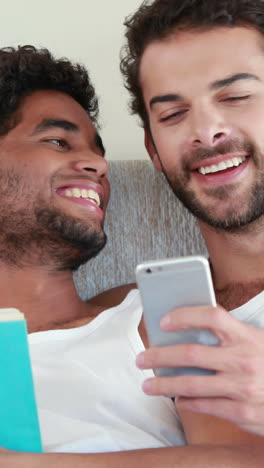 homosexual couple speaking together on bed