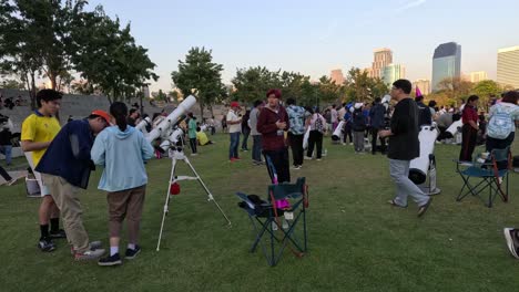 people gather in park for public stargazing event