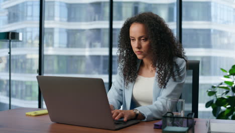 Focused-manager-typing-keyboard-panoramic-office-closeup.-Ceo-browsing-internet