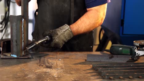 welder welding a metal in workshop