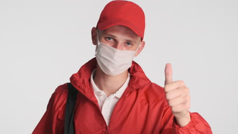 young man in red uniform giving thumb up