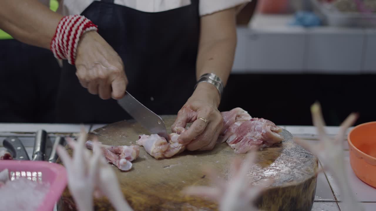Preparing Raw Chicken at a Market