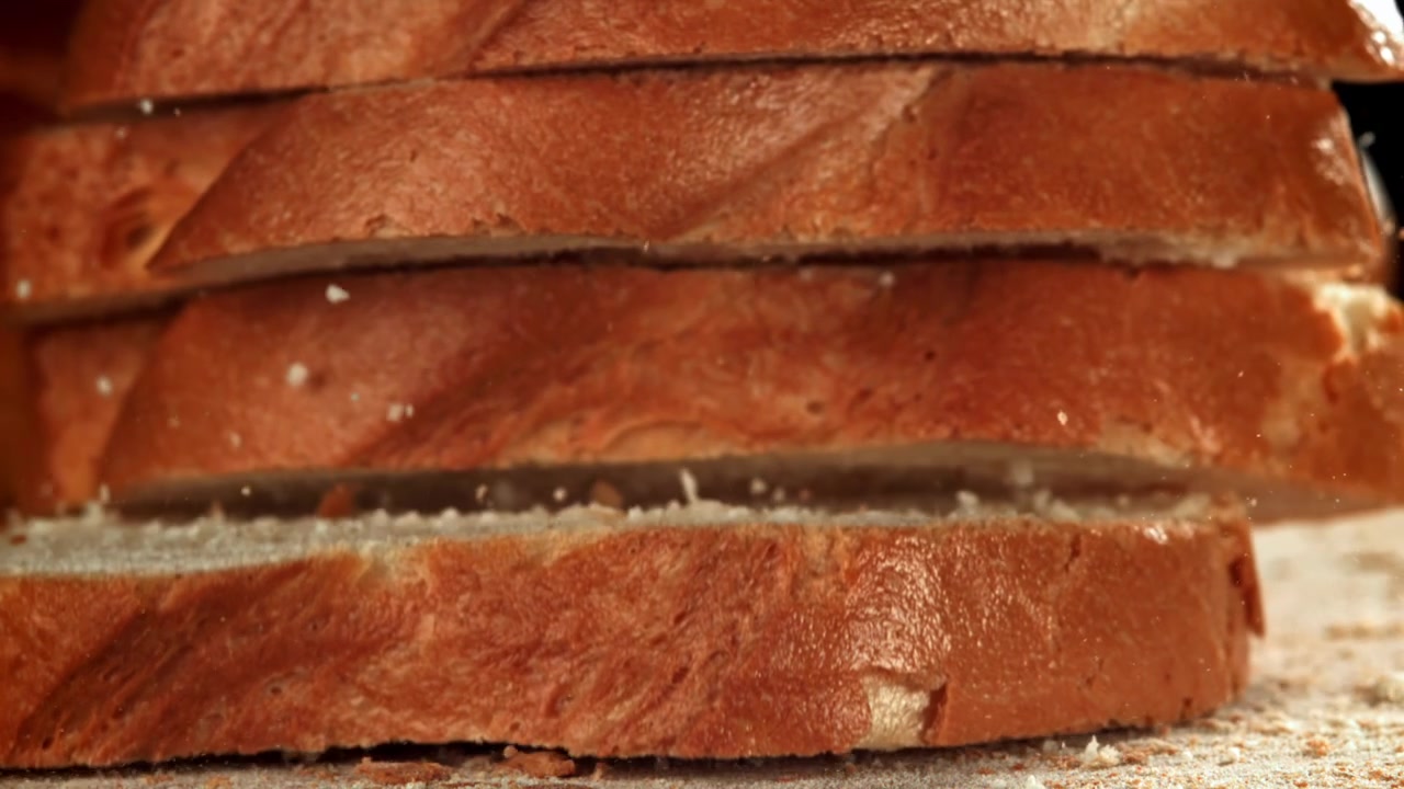 Slices of Fresh Bread Falling and Stacking in Slow Motion