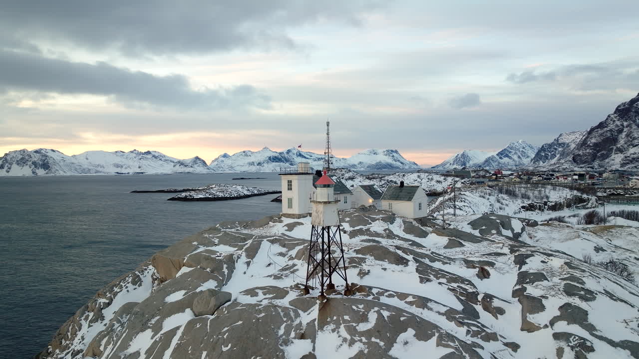 Henningsvaer Lighthouse on snowy rocky island, V&aring;gan, Lofoten