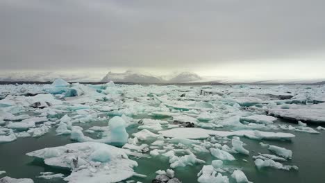 flying over iceberg in water, melting glacier, climate change