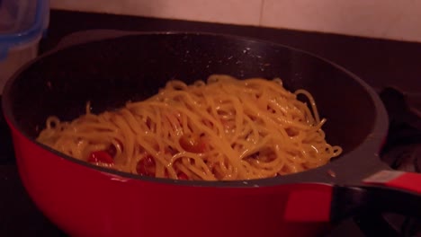 slow motion shot of cooking spaghetti movement with tomato sauce in pot