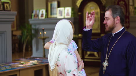 woman and child approaching priest