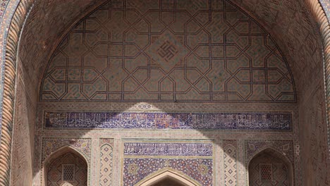 lights and shadows hit the arched doorway of islamic architecture in samarkand, uzbekistan along the historic silk road