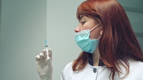 female patient at the dentist's having local anesthesia in clinic. stomatologist woman holding a syringe with analgesic before the procedure