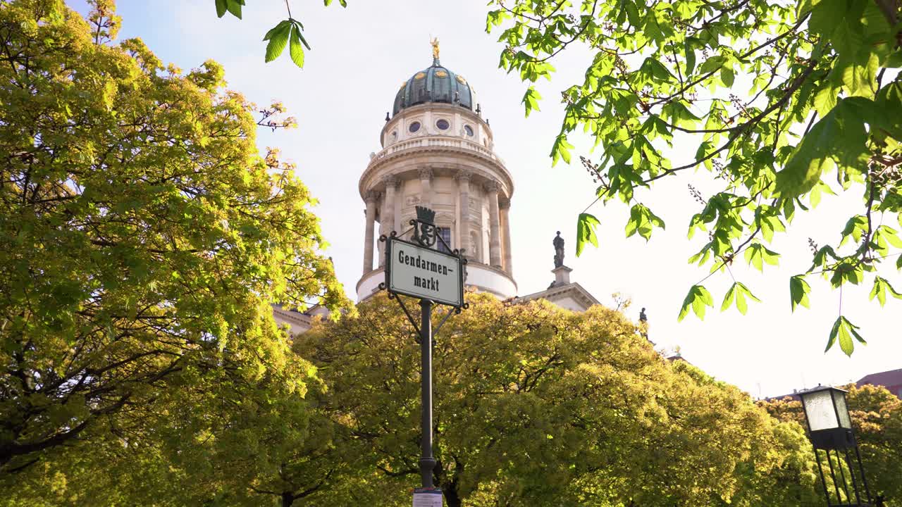 나무 사이에 프랑스 교회 탑이 있는 목가적인 젠다르멘마르크트 베를린