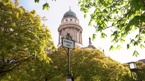 Idyllic-Gendarmenmarkt-Berlin-with-Tower-of-French-Church-between-Trees