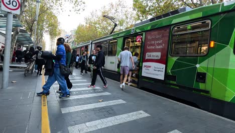 people boarding and alighting a tram