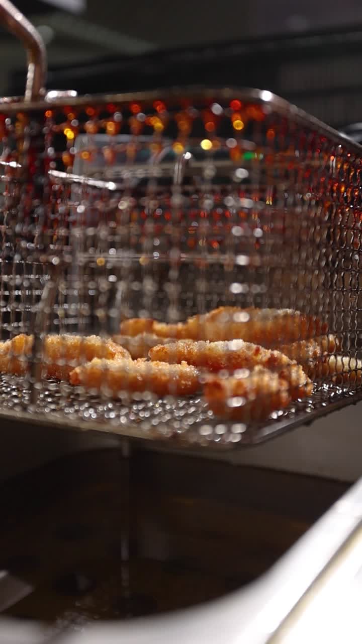 Food being deep fried in a commercial fryer
