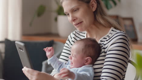 young mother using smartphone calming baby crying at home mom soothing unhappy infant caring for child