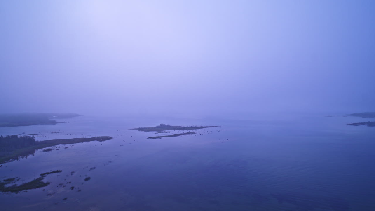 drone shot flying through foggy conditions 20-50 feet above lake michigan