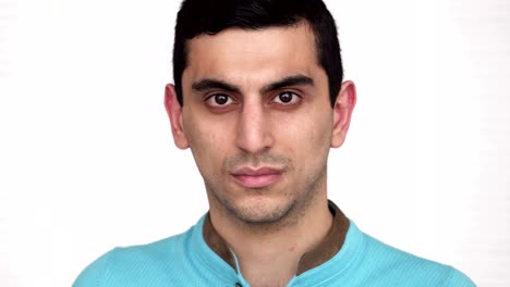 primer plano de la cara de un joven serio del medio oriente