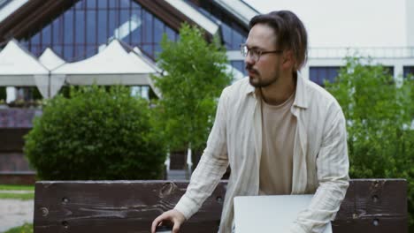 man working and having coffee break in the park