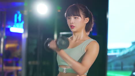 attractive muscular woman trains muscles of shoulders with lifting barbell with heavy weight in gym. young healthy sportswoman squatting with heavy weights. lose weight concept