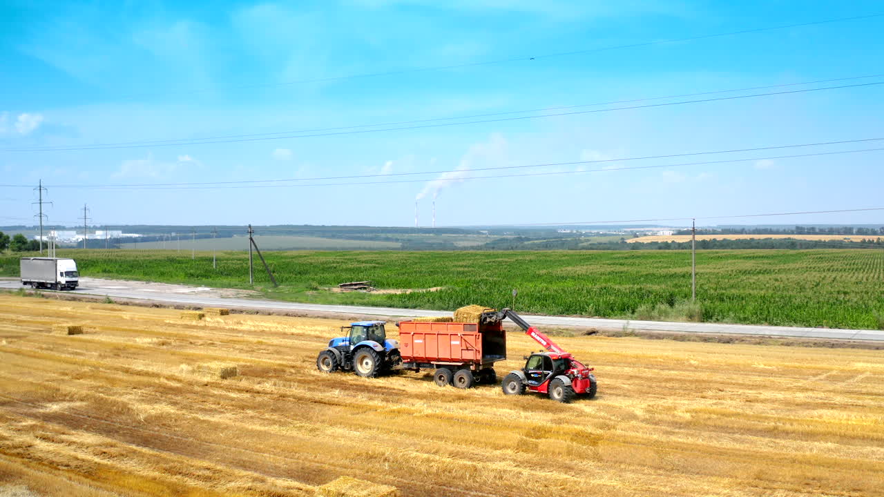 Bales of hay stacked in trailer. Agricultural field after harvest prepared for farming stack