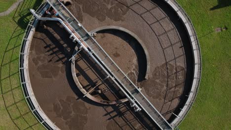 aerial top down view of wastewater treatment plant with green grass