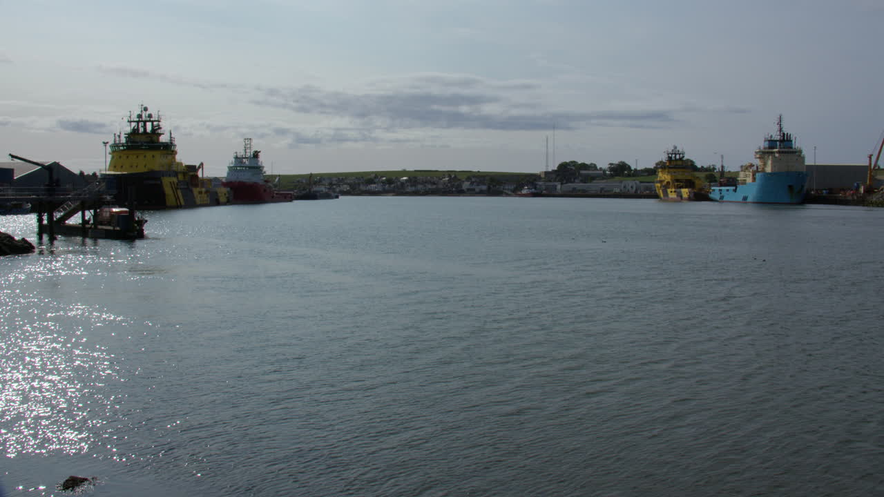 Extra Wide shot of commercial seagoing ships in harbour at river south Esk, Montrose