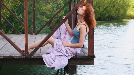woman sitting on a pier by a lake
