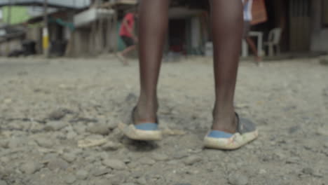 feet of children playing football on the street of poor neighborhood in buenaventura in colombia