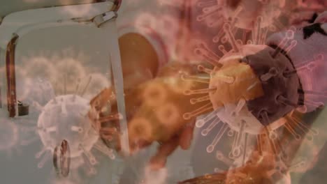 animación de células de macro coronavirus covid-19 que se propagan sobre un padre e hijo lavándose las manos