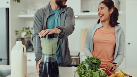 couple making a smoothie in the kitchen
