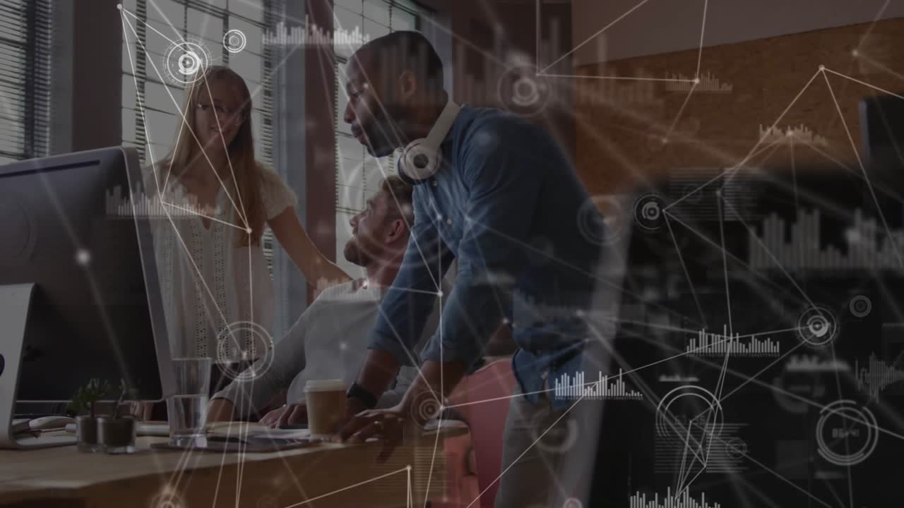 Business team leaning around screen, standing man pointing, colleagues gesturing and agreeing plan