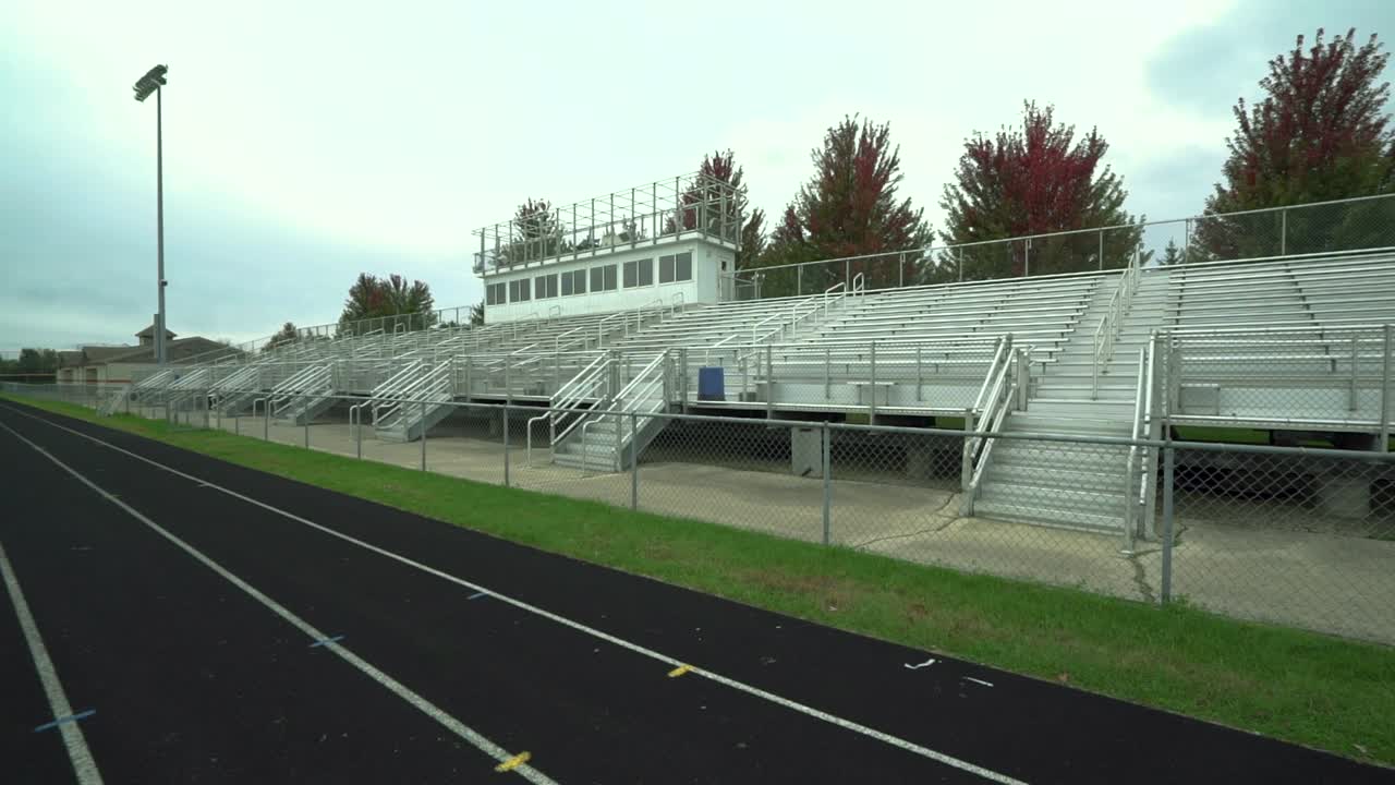 A panning shot of bleachers at high school American Football field.