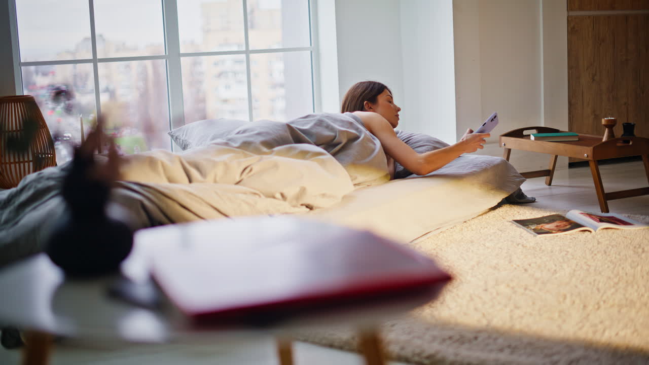 Morning girl sleeping mattress light apartment. Lazy woman waking up stretching