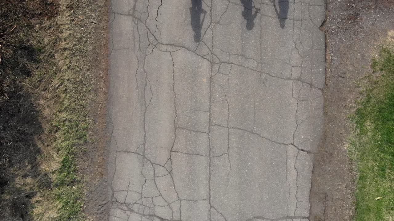 Aerial Drone Over Head Kids Riding Bicycles